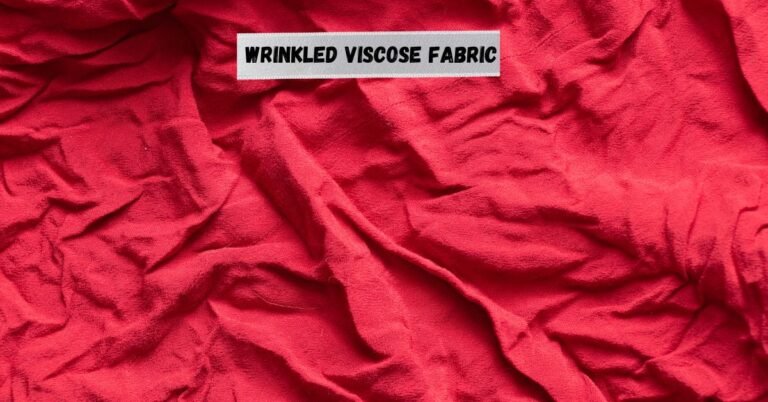Wrinkled red viscose fabric showing how viscose wrinkles easily.