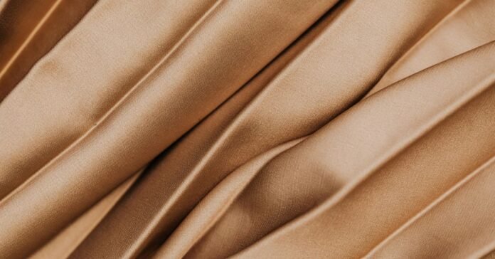 Smooth, glossy folds showing what is satin silk fabric? texture and shine.