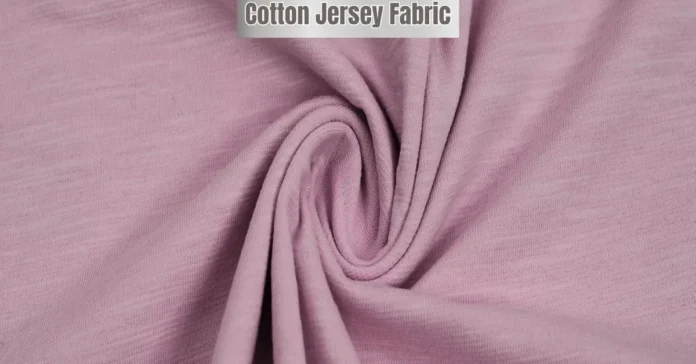 Close-up of soft pink cotton jersey fabric with visible stretch and smooth texture