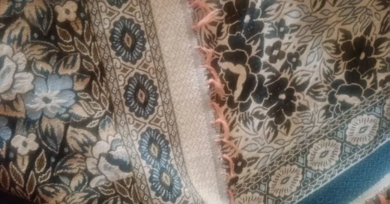 Close-up of cotton jacquard fabric featuring intricate floral and geometric woven patterns in muted tones