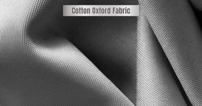 Close-up of folded gray Cotton Oxford fabric showing fine weave texture.