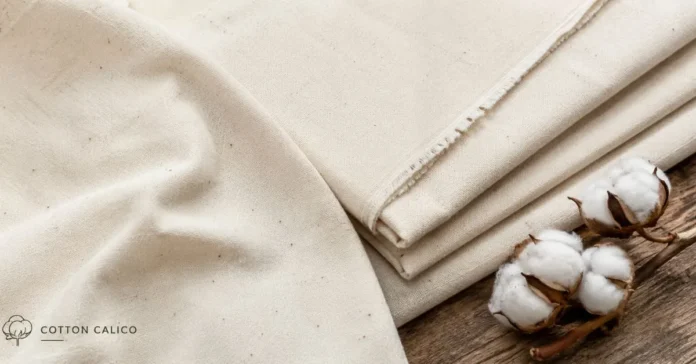 Folded beige calico fabric with cotton bolls