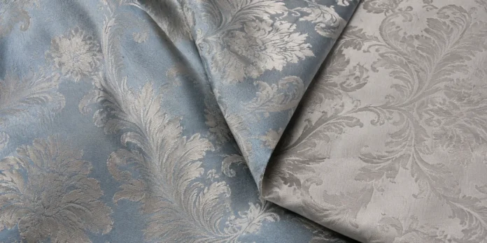 Front and reverse sides of blue and silver damask fabric