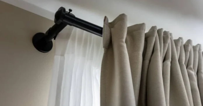 How to layer curtains using double rods, with inner sheer and outer drape layers and fabric clearance labelled