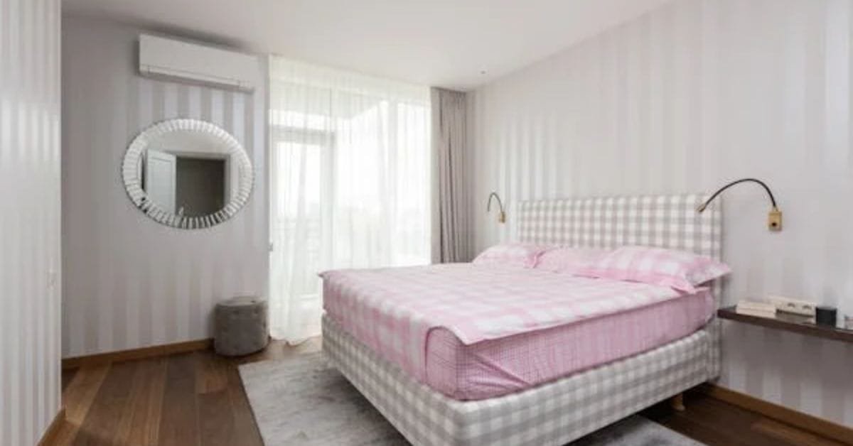 Soft pink bedsheets on a cozy bedroom bed.