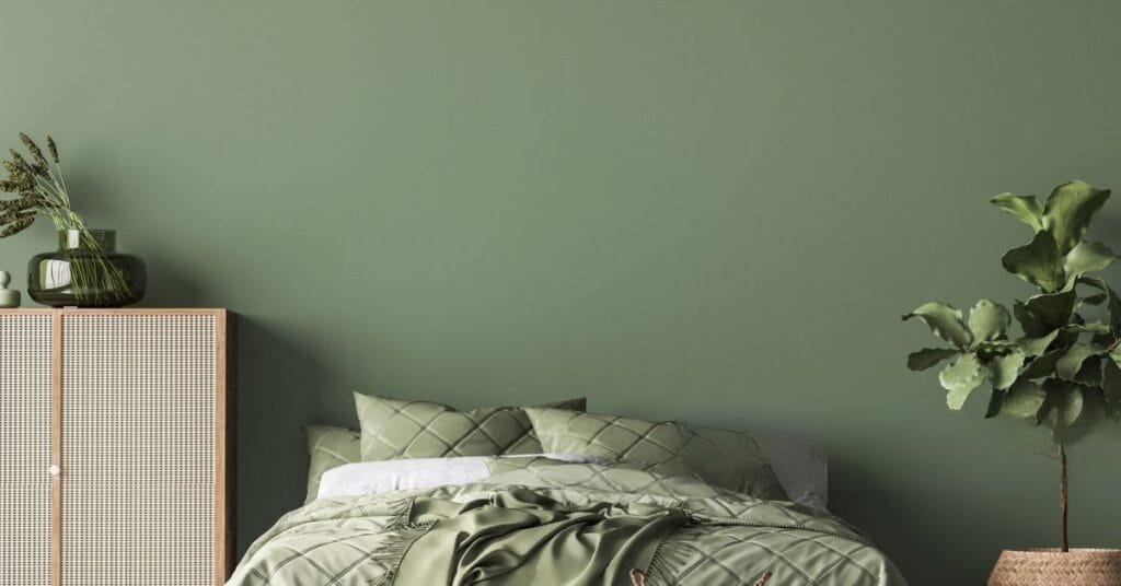 Green bedsheets styled in a fresh, nature-inspired bedroom