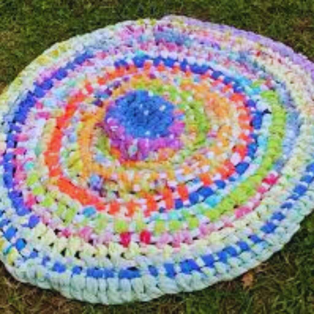 Vibrant knotted rag rugs with a textured surface.