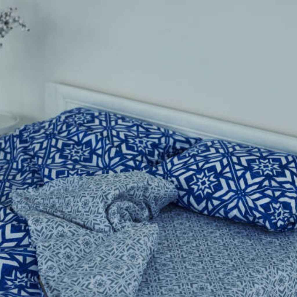 Reversible bedsheets with two design options in a modern setting.