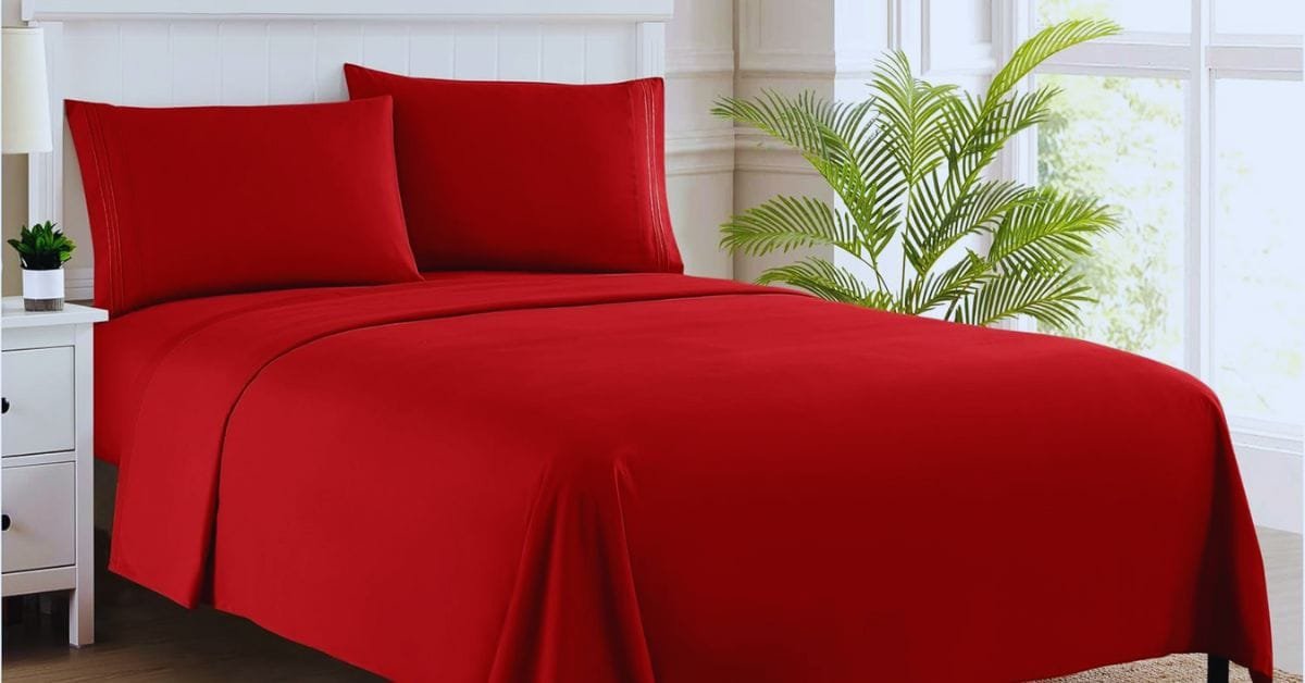 Red bed sheets creating a bold, vibrant look in a modern bedroom.